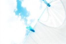 青い洗濯バサミで干した白いシャツ